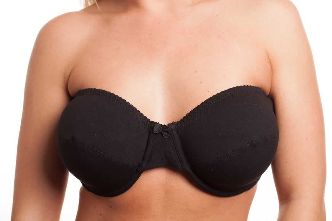 top halp of a woman wearing a black strapless bra