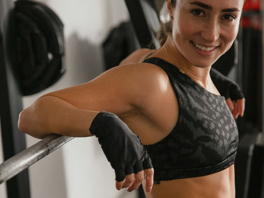 woman standing in a gym wearing a sports bra