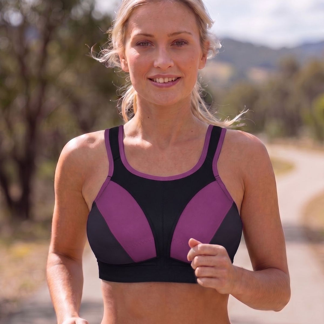blonde woman running wearing a black purple multiway bra